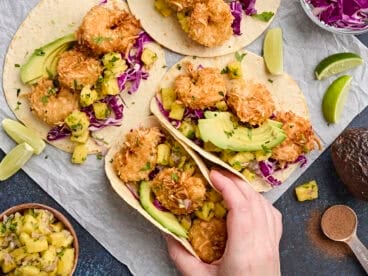 Overhead view of coconut shrimp tacos with pineapple salsa.