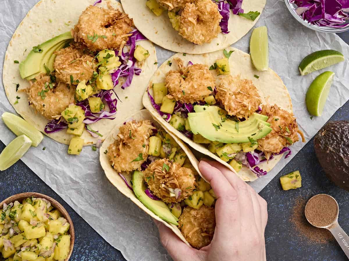 Overhead view of coconut shrimp tacos with pineapple salsa.