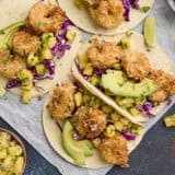Overhead view of coconut shrimp tacos with pineapple salsa.