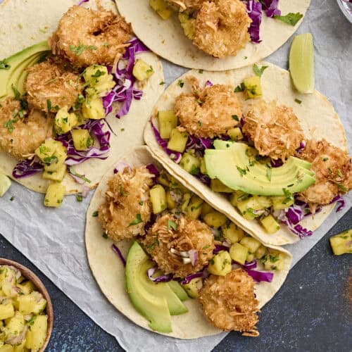 Overhead view of coconut shrimp tacos with pineapple salsa.