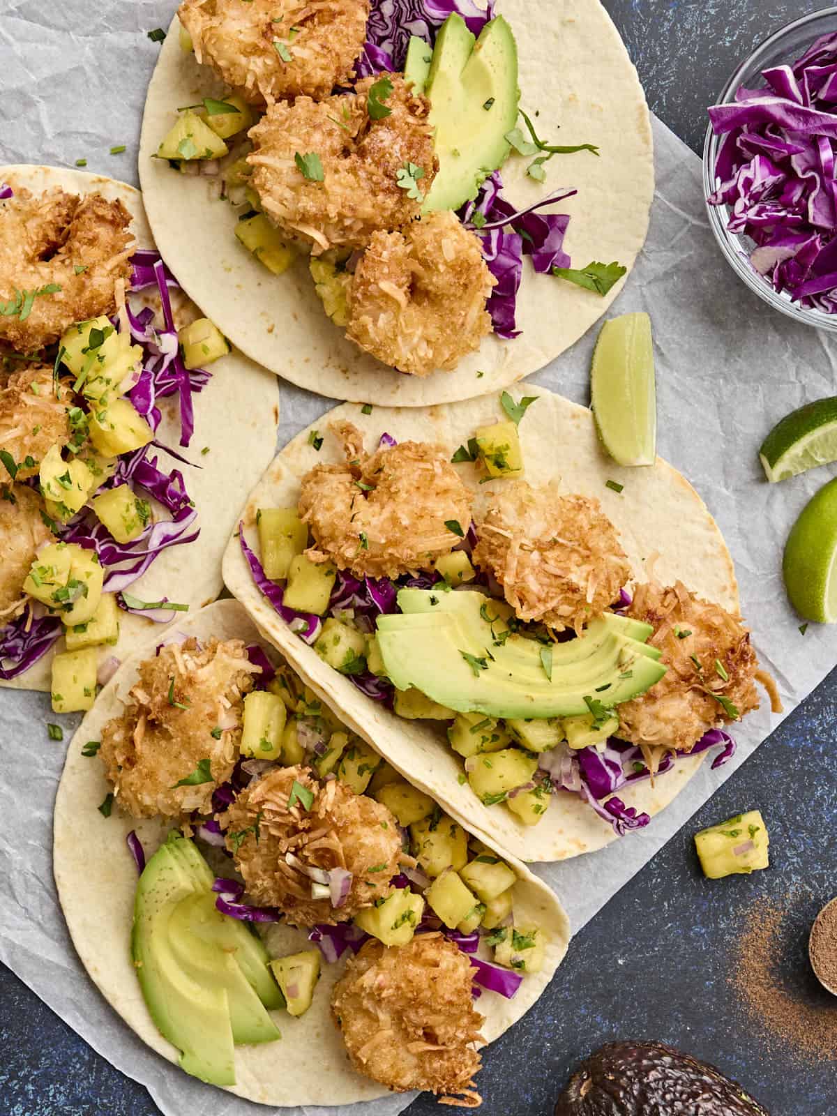 Overhead view of homemade coconut shrimp tacos with pineapple salsa.