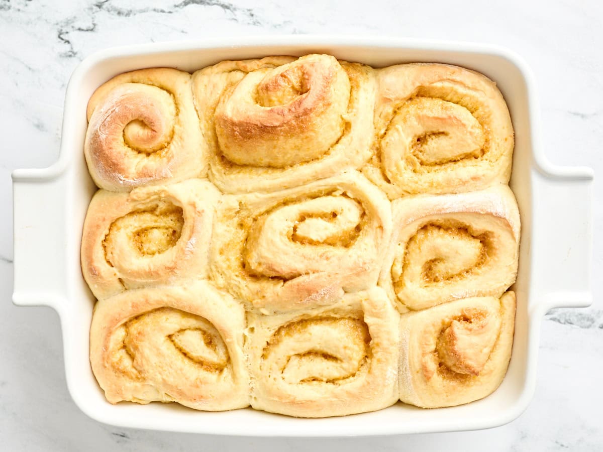Freshly baked homemade orange rolls in a baking dish.