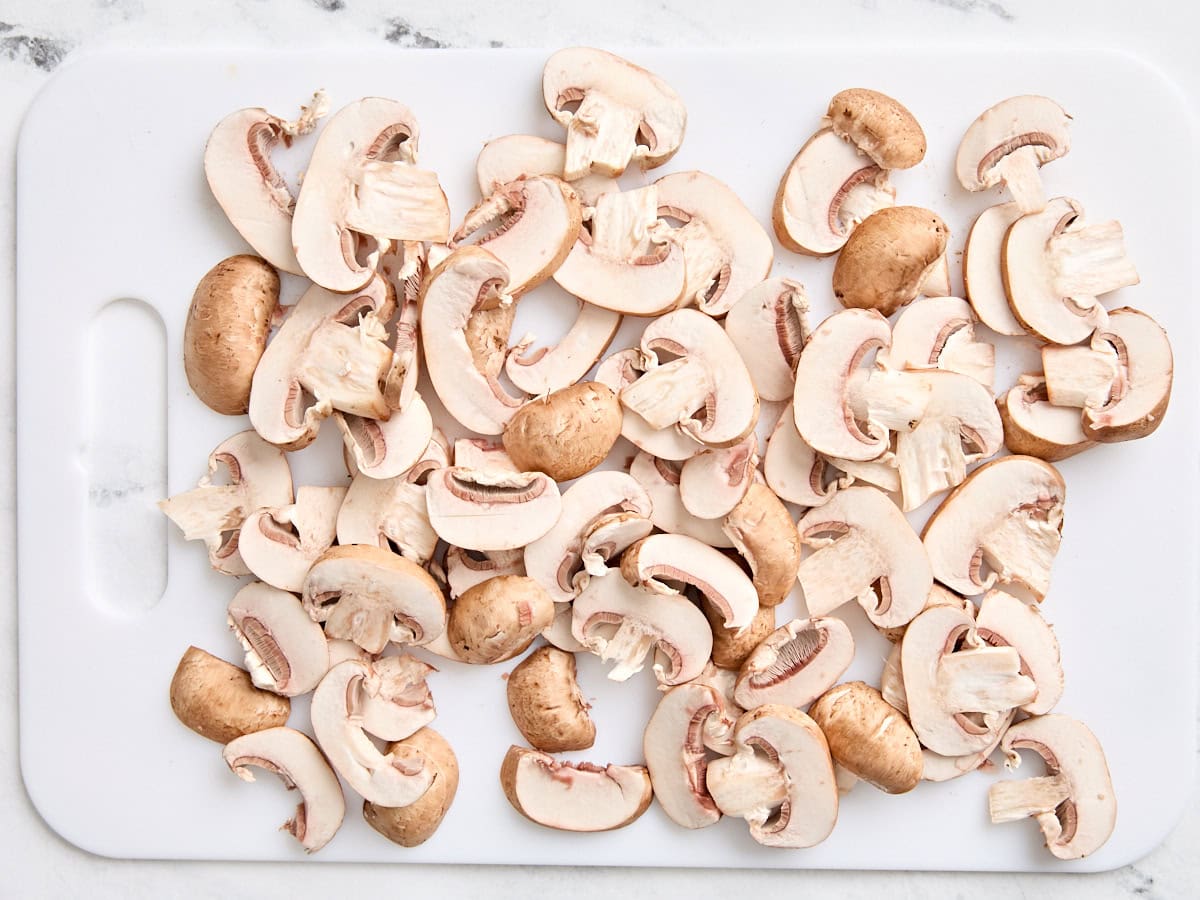 Sliced mushrooms on a cutting board.