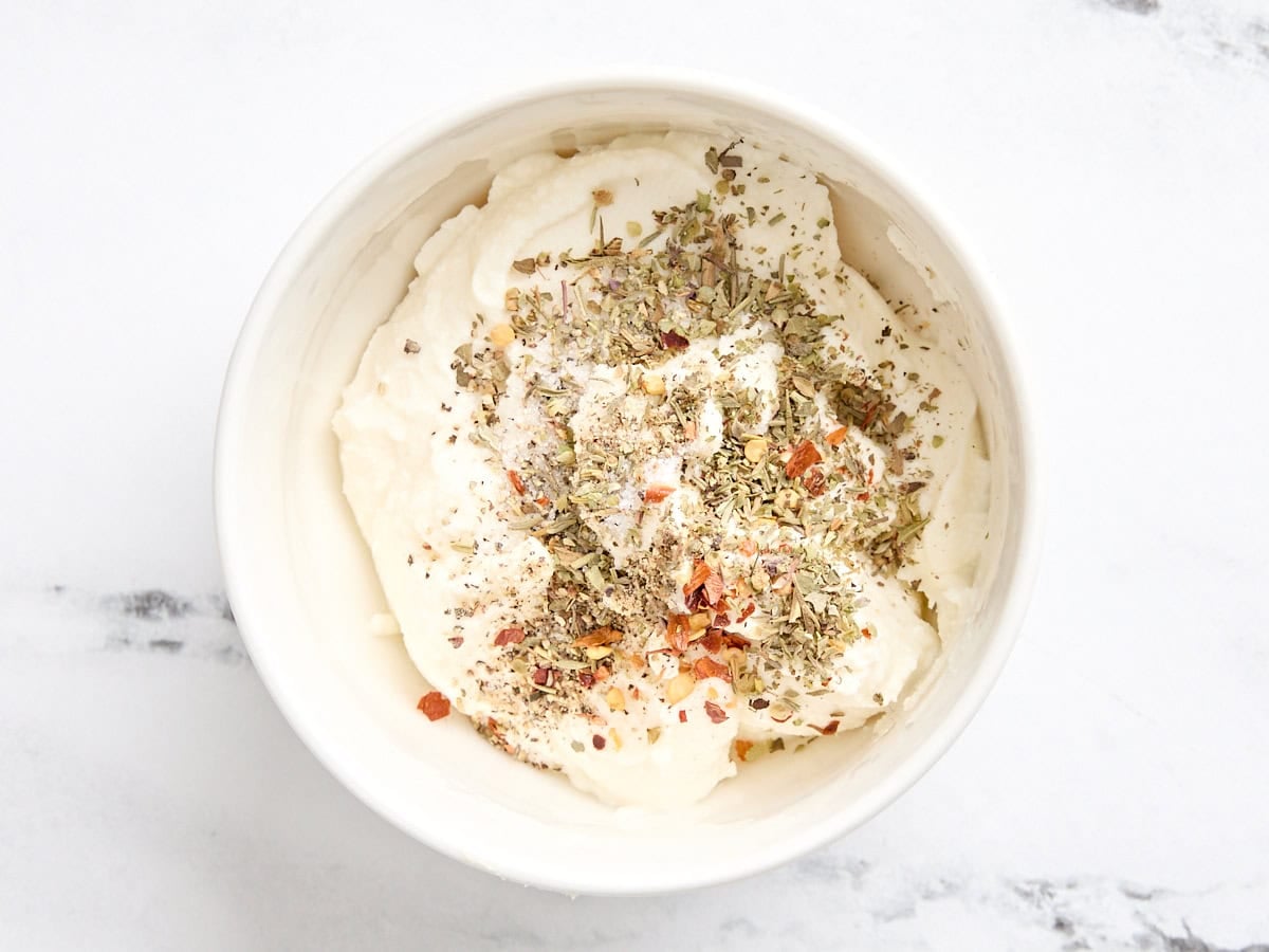 The cheese filling for a calzone in a bowl.
