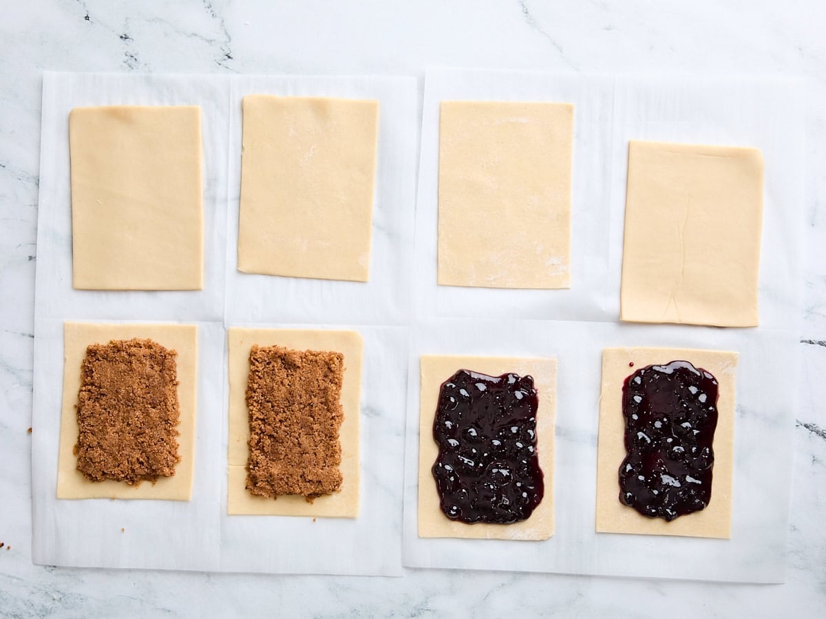 Brown sugar filling added to two pie crust rectangles and blueberry jam filling added to 2 pie crust rectangles.