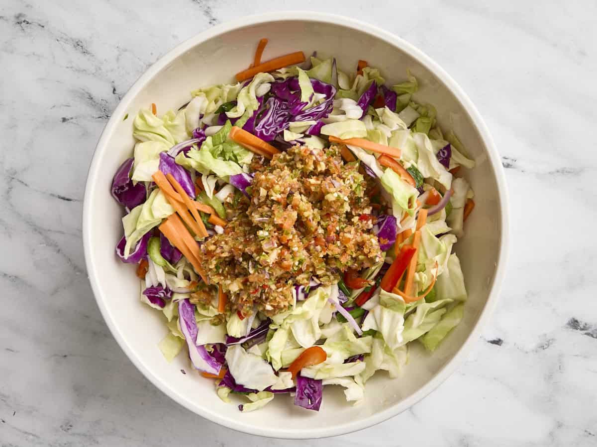Processed vegetables and prepped vegetables in a mixing bowl.