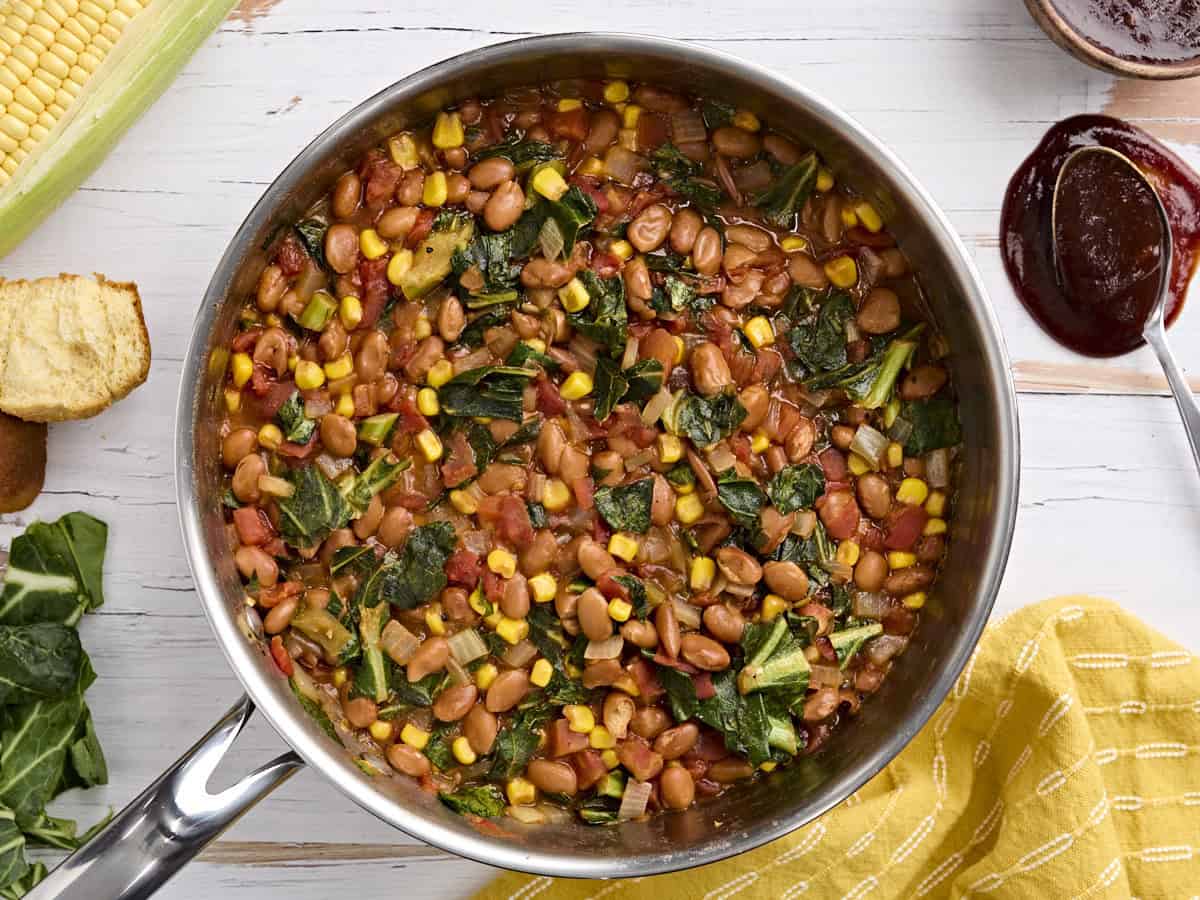 Overhead view of a skillet of bbq beans and greens.