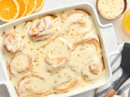 Overhead view of homemade orange rolls in a baking dish.
