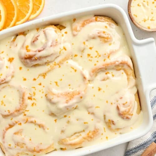 Overhead view of homemade orange rolls in a baking dish.