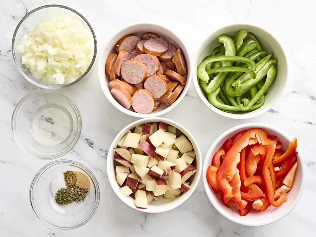 Overhead view of the ingredients to make a grilled sausage and peppers foil packet.