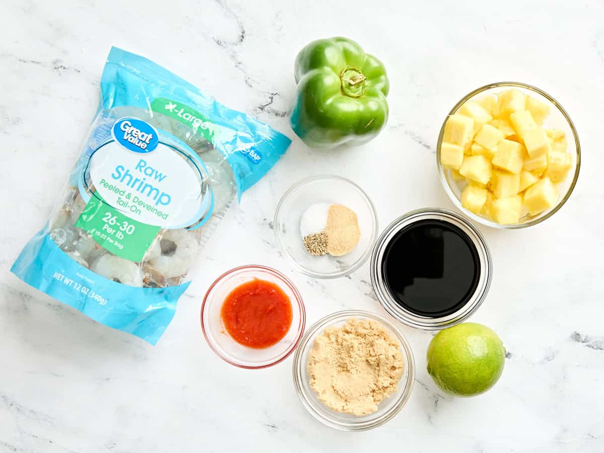 The ingredients to make grilled shrimp and pineapple skewers.