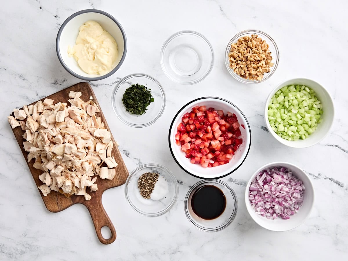 The ingredients to make a strawberry chicken salad.