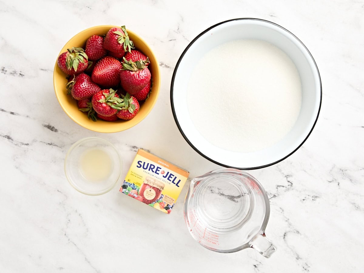 The ingredients to make strawberry freezer jam.