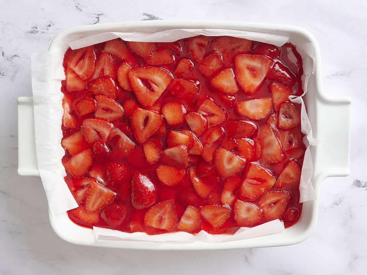 Strawberry jello salad in a baking dish after chilling.
