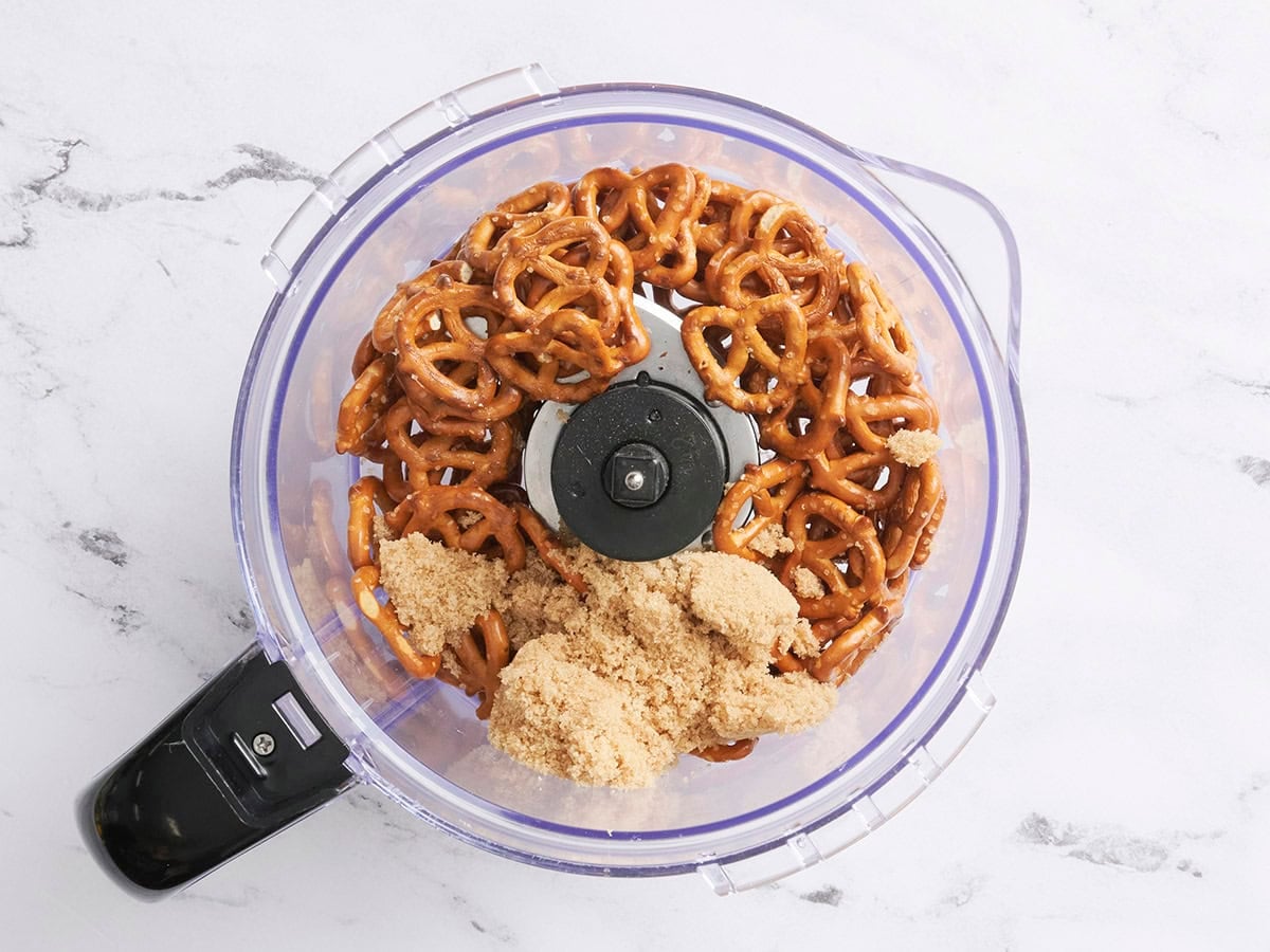 Salted pretzels and brown sugar in a food processor.