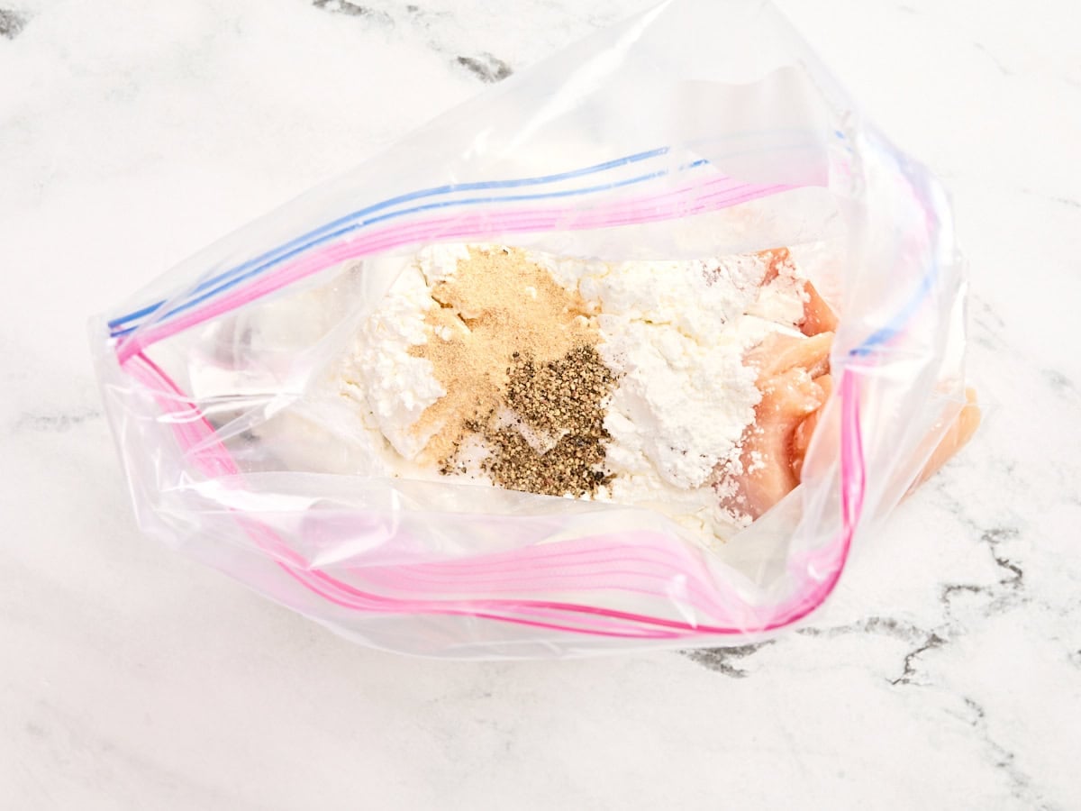 Cornstarch, seasonings, and diced chicken breast in a ziploc bag.