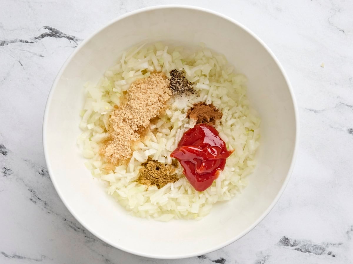 The ingredients to make homemade onion chutney in a bowl