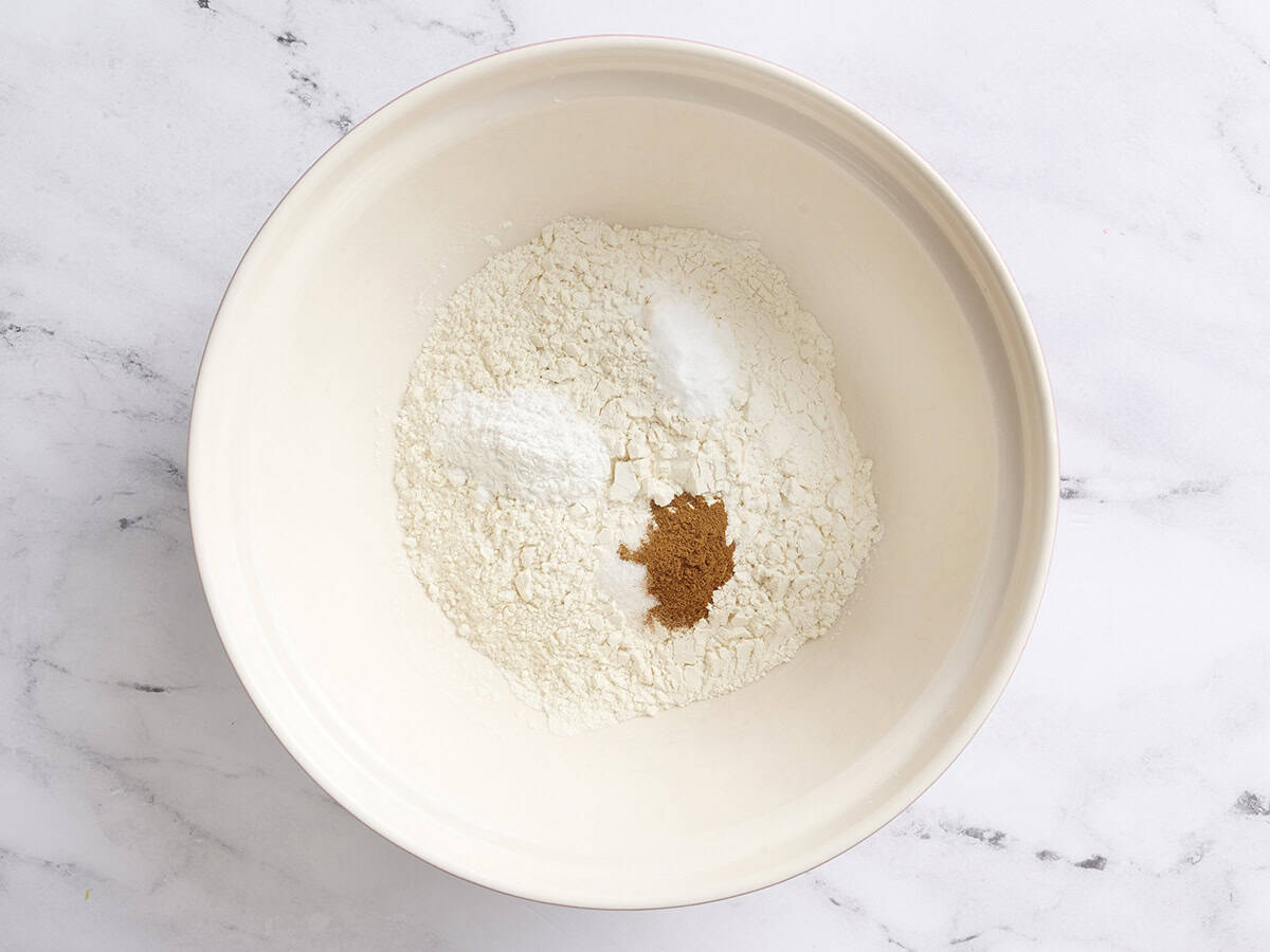 Flour, spices and raising agents in a mixing bowl.