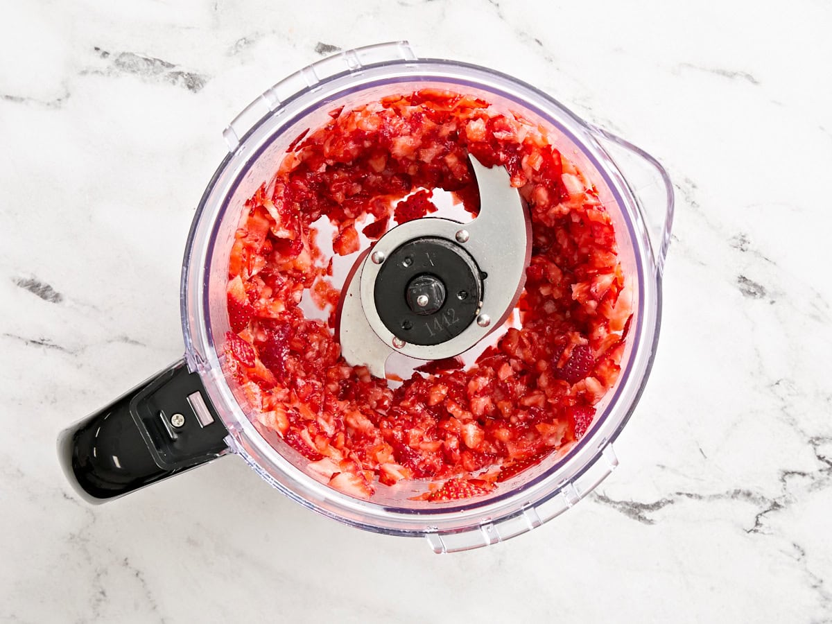 Coarsely chopped strawberries on a food processor.