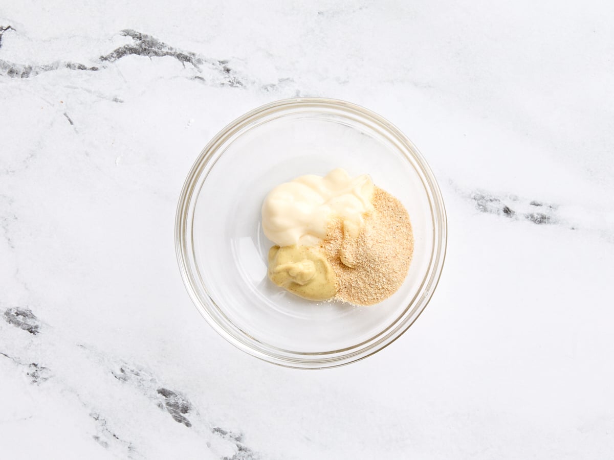 Garlic powder, mayonnaise, and Dijon mustard in a bowl