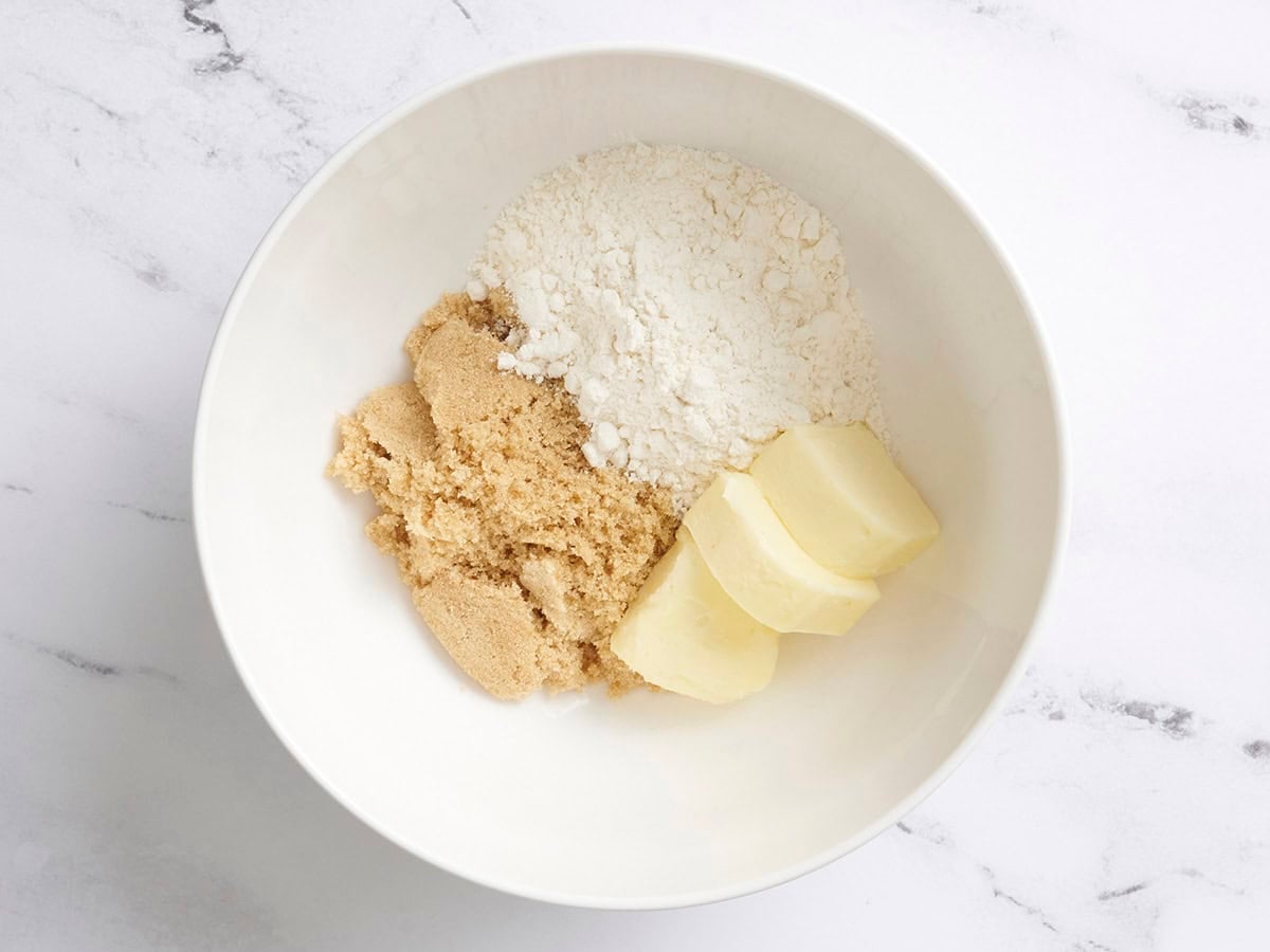 Flour, butter, and brown sugar in a mixing bowl.