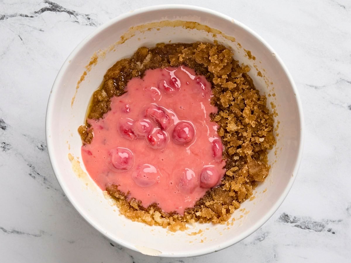 The wet ingredients for cherry blondies added to the creamed butter and sugar.