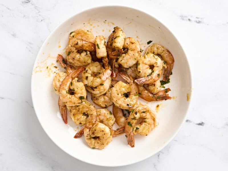 A plate of cooked grilled shrimp.