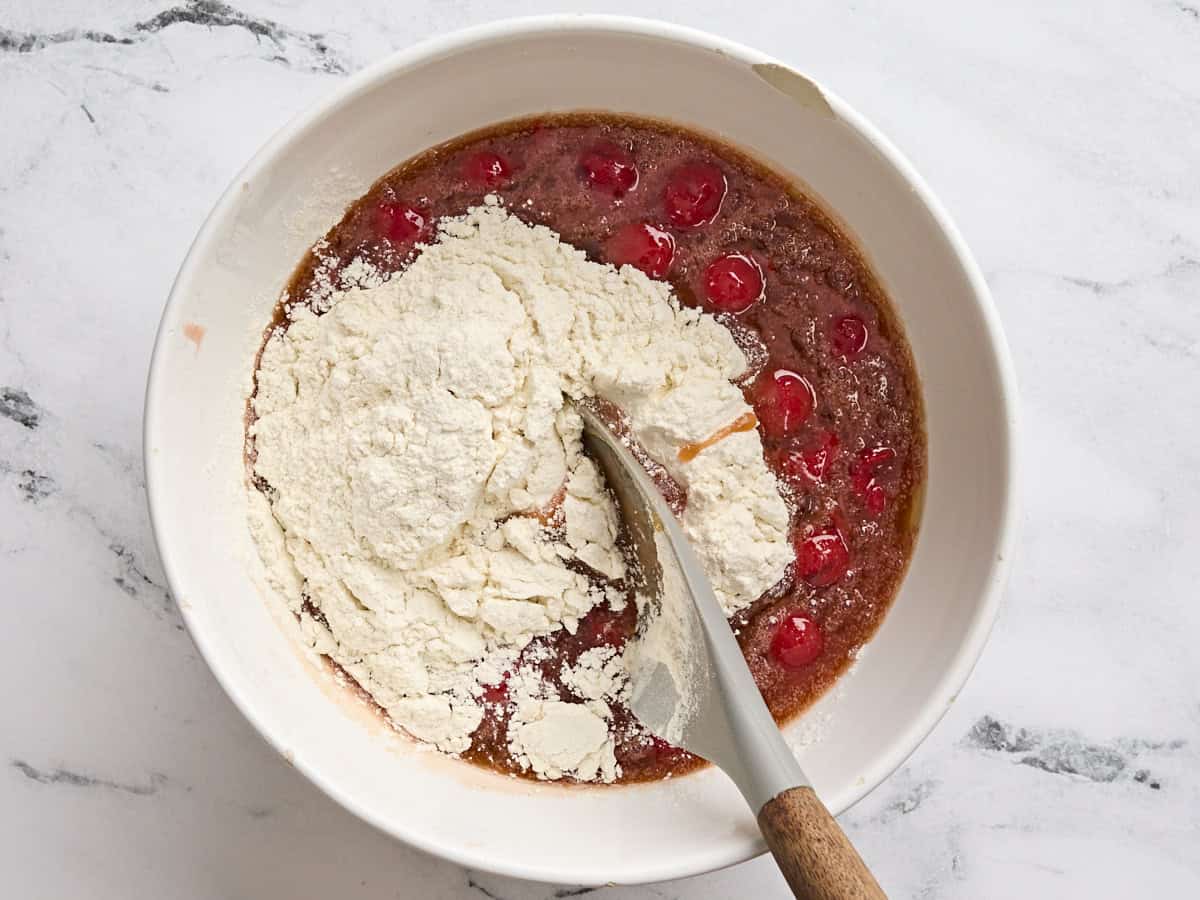 Dry ingredients added to the wet ingredients to make cherry blondies.