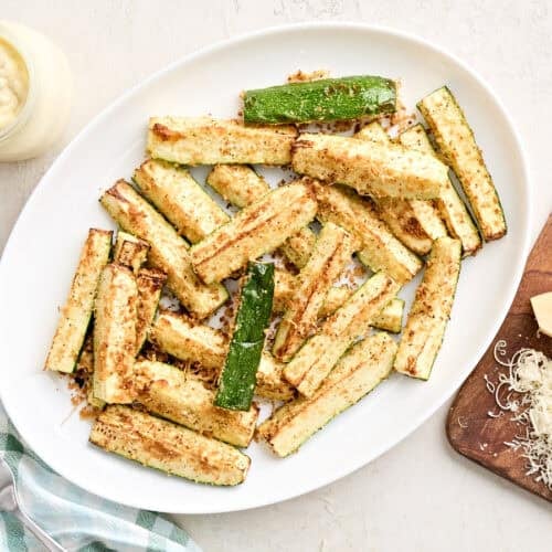 Overhead view of air fried zucchini on a plate.