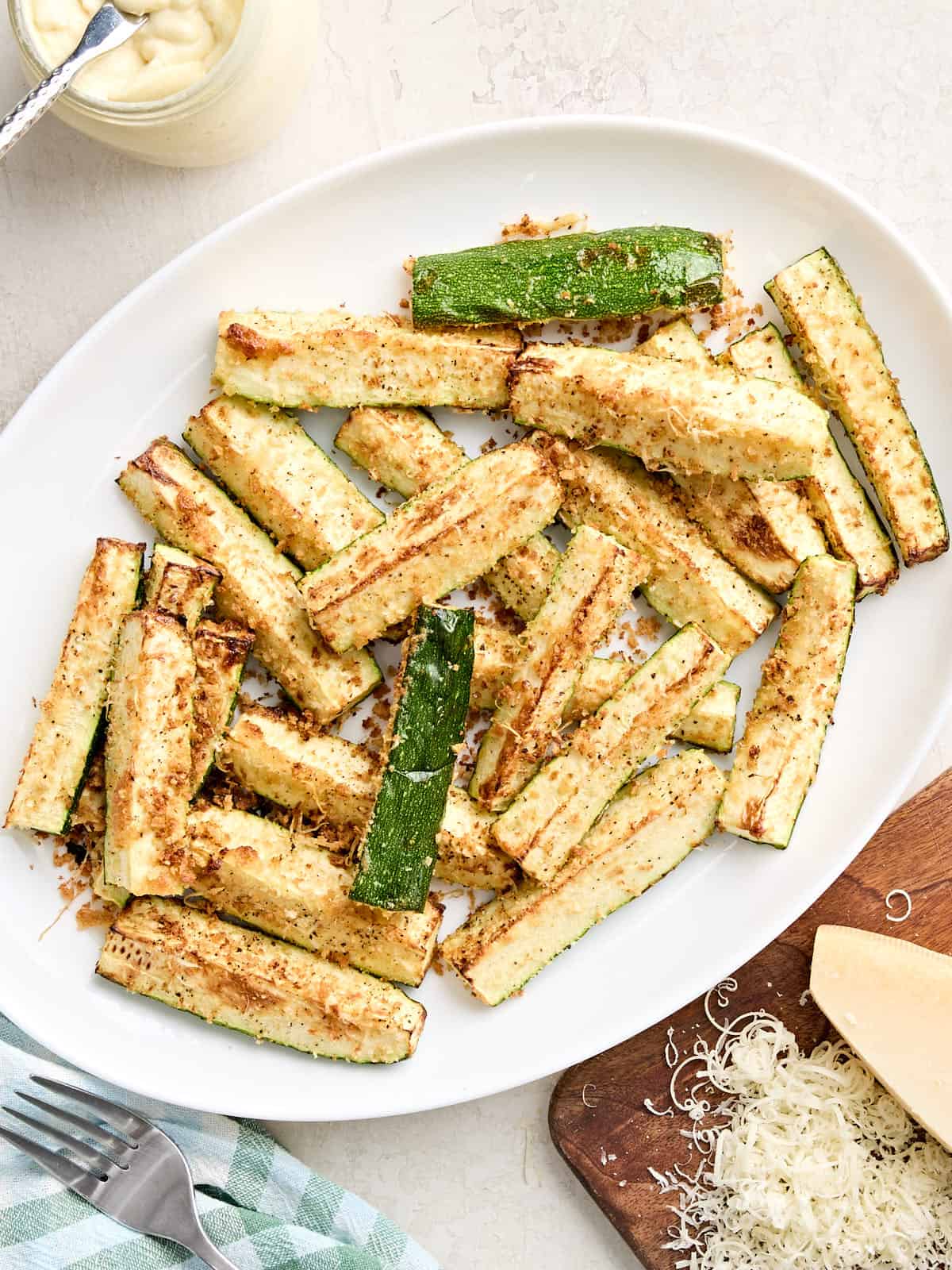Overhead view of air fryer zucchini on a plate.