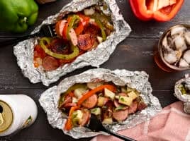 Overhead view of two foil packets with a fork taking some.