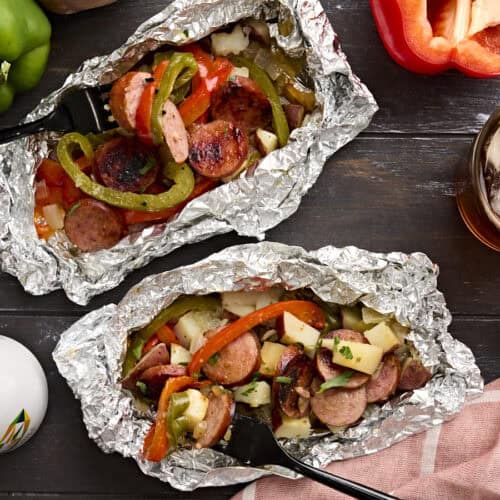 Overhead view of two foil packets with a fork taking some.