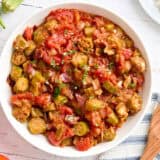 Overhead view of a bowl of stewed tomatoes and okra.