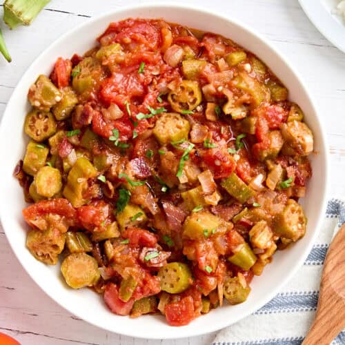 Overhead view of a bowl of stewed tomatoes and okra.