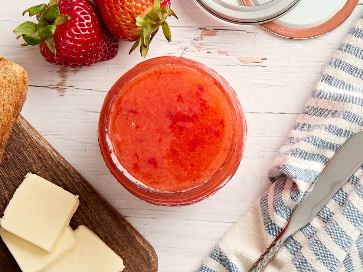 Overhead view of a jar of strawberry freezer jam.