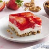 Side view of a slice of homemade strawberry pretzel salad.