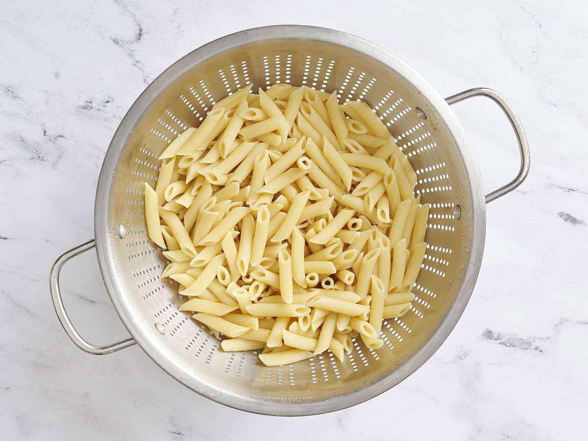 Cooked pasta in a colander.