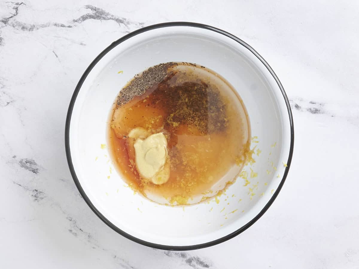 Summer lentil salad vinaigrette ingredients in a bowl.