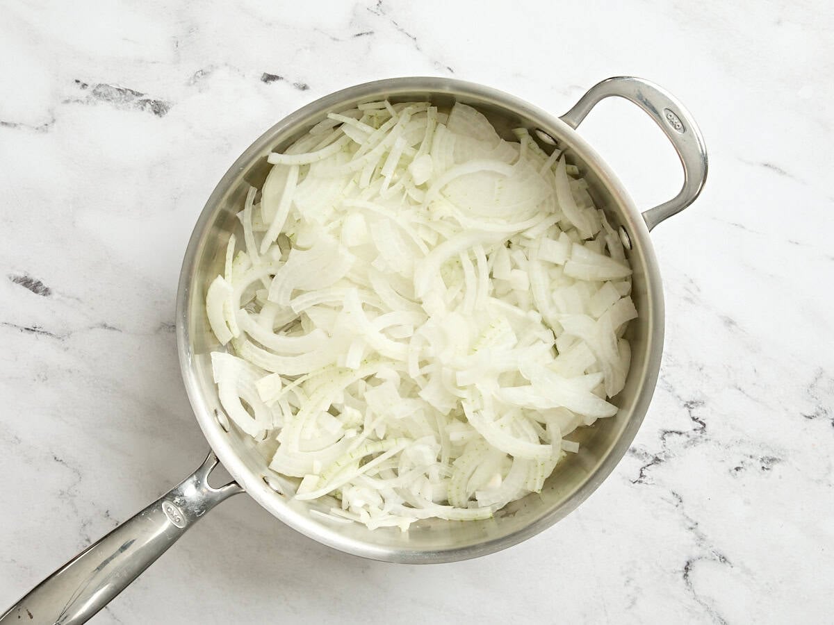 Sliced onions in a skillet.