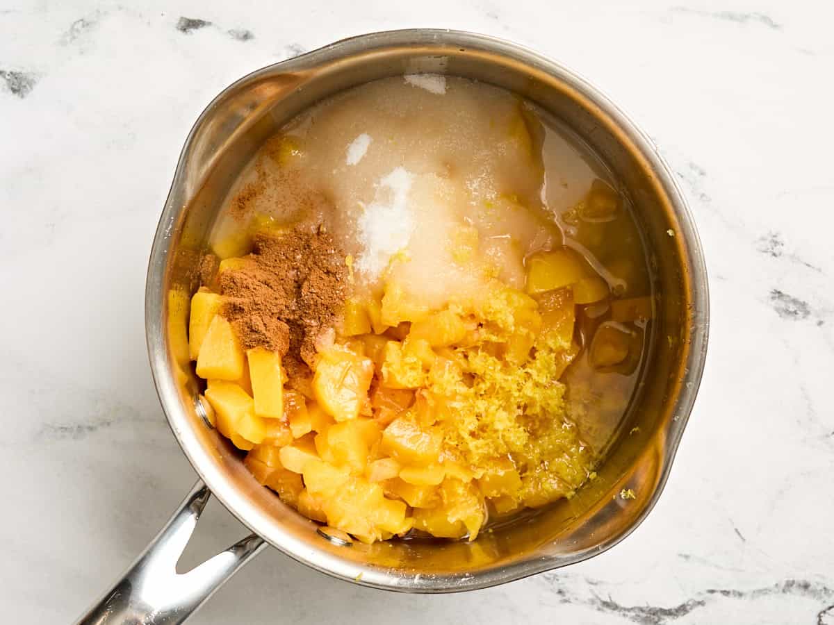 Peach sauce ingredients in a sauce pan.
