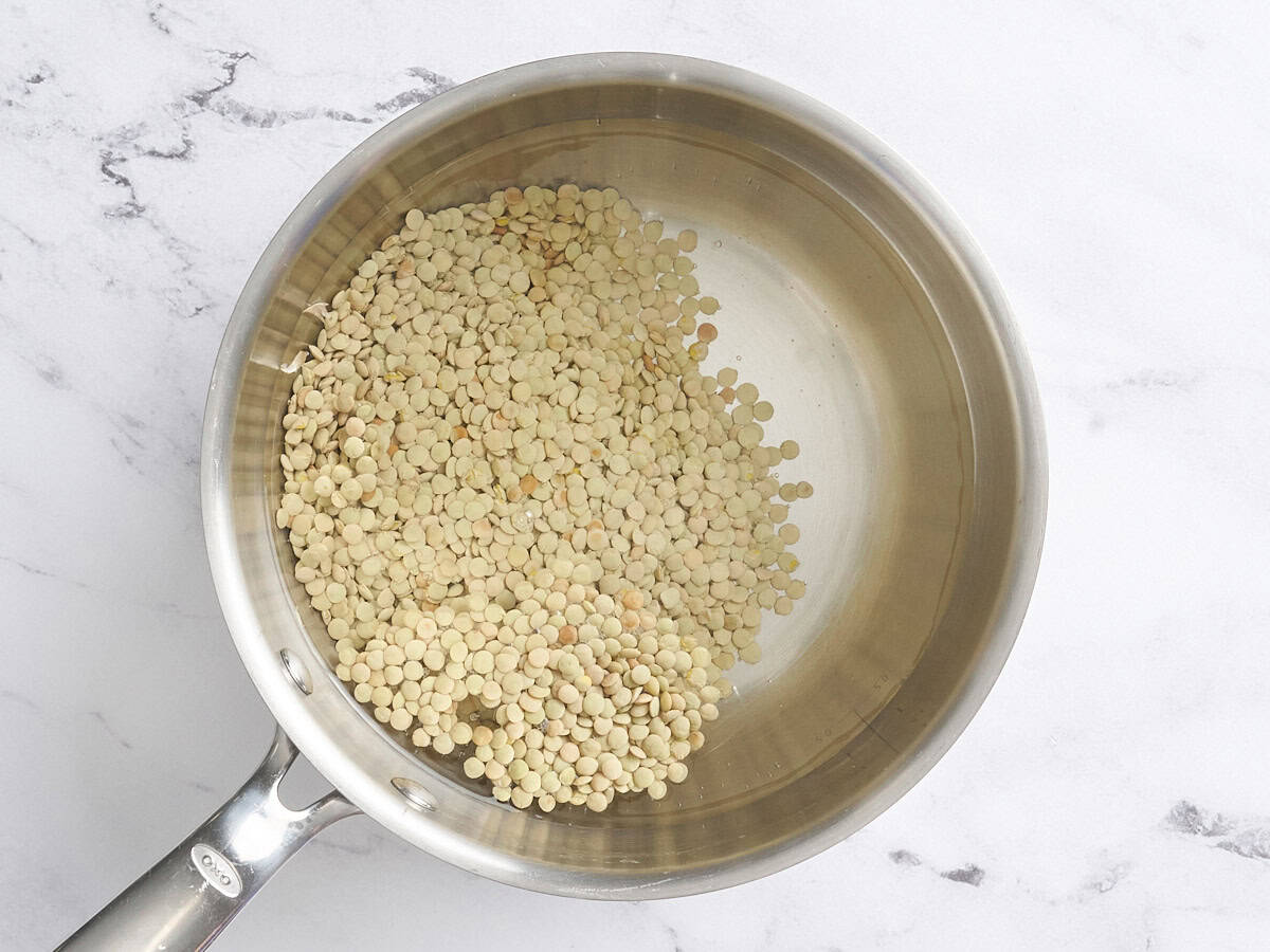 Lentils in a pot of water.