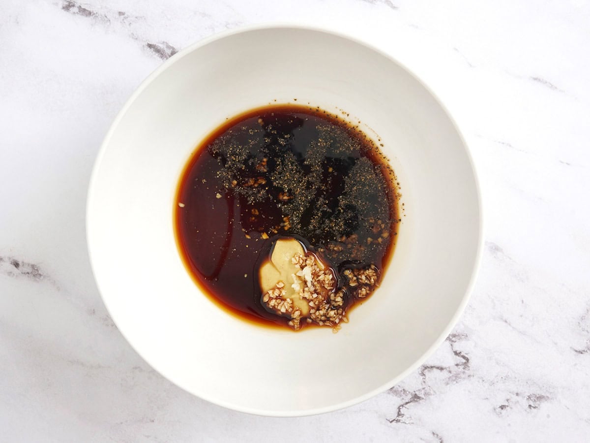 The ingredients for a balsamic vinaigrette in a bowl.