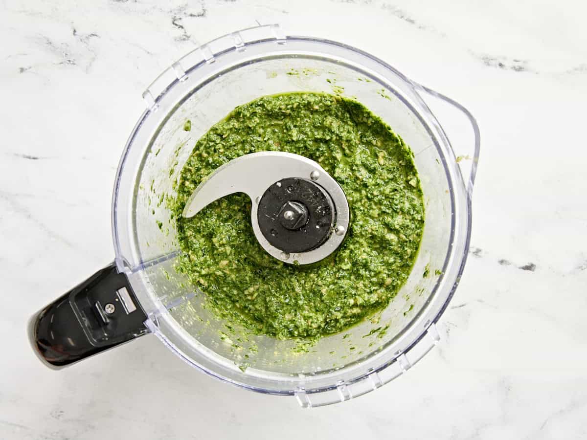 Homemade budget friendly pesto in a food processor.