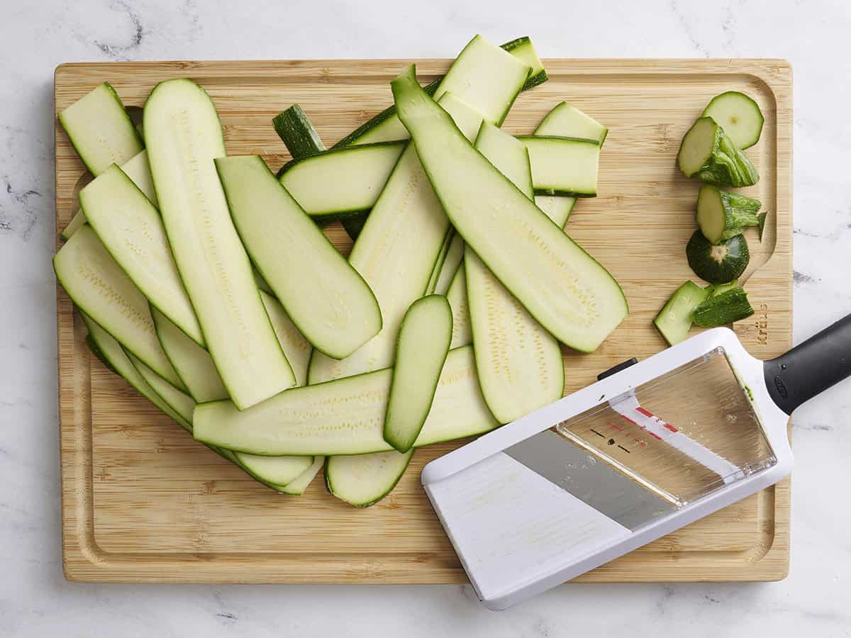 Zucchini sliced using a mandoline slicer.