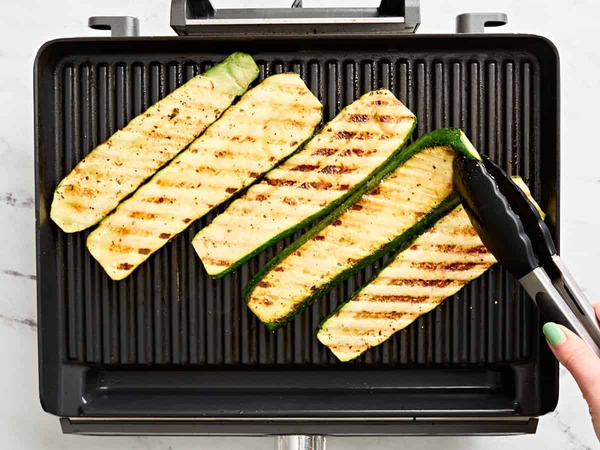 Zucchini slices on a grill.