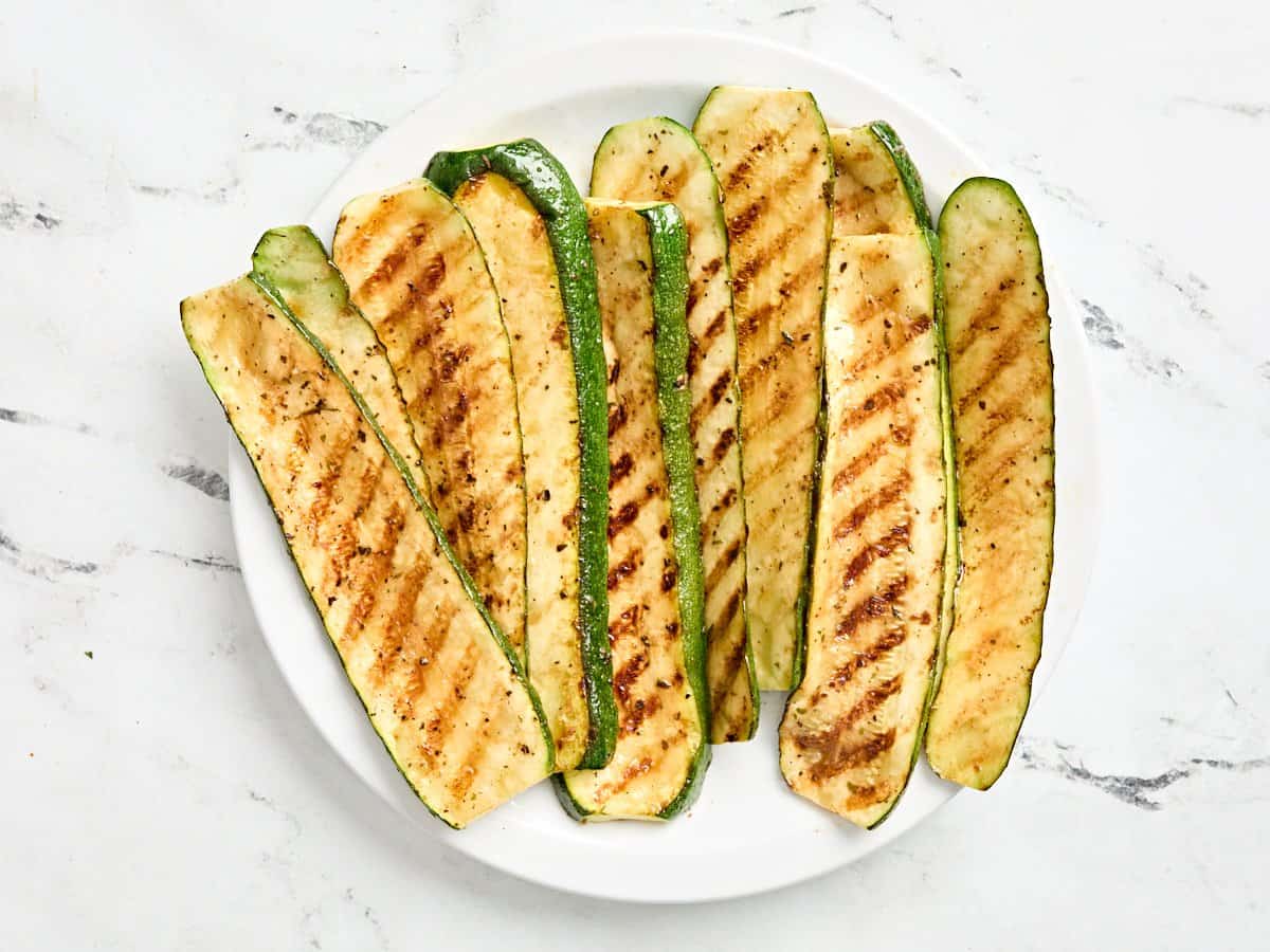 Grilled zucchini slices on a plate.
