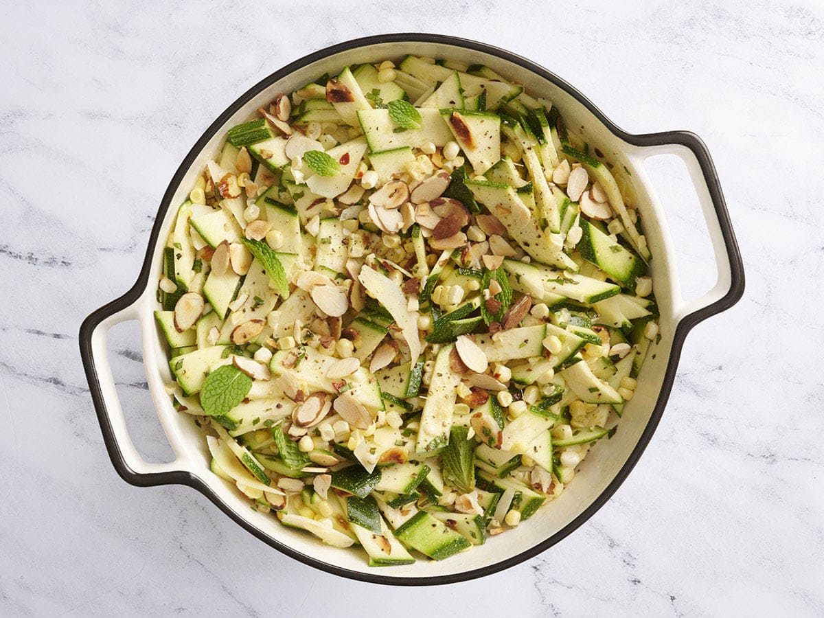 A bowl of zucchini, corn and toasted almond salad.