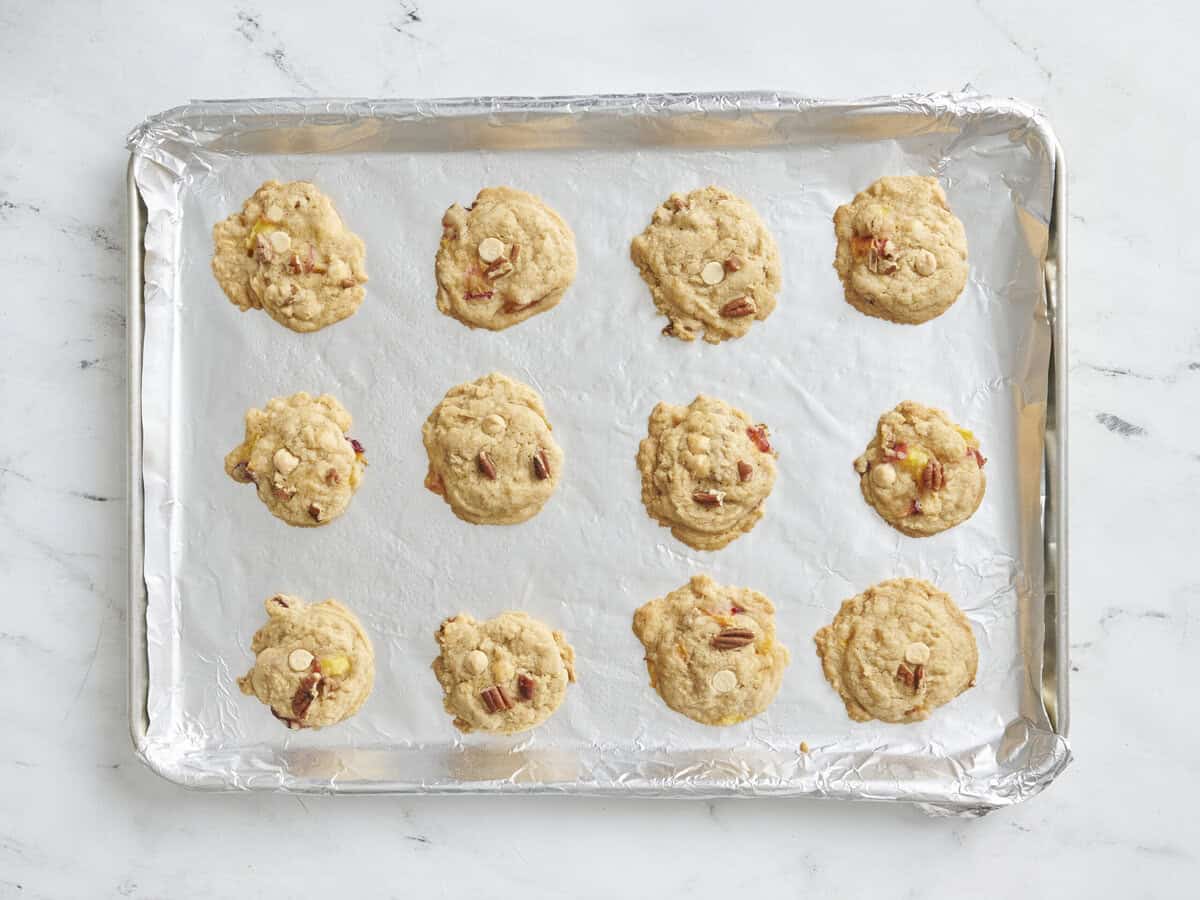 Peaches and cream cookies on a cookie sheet.
