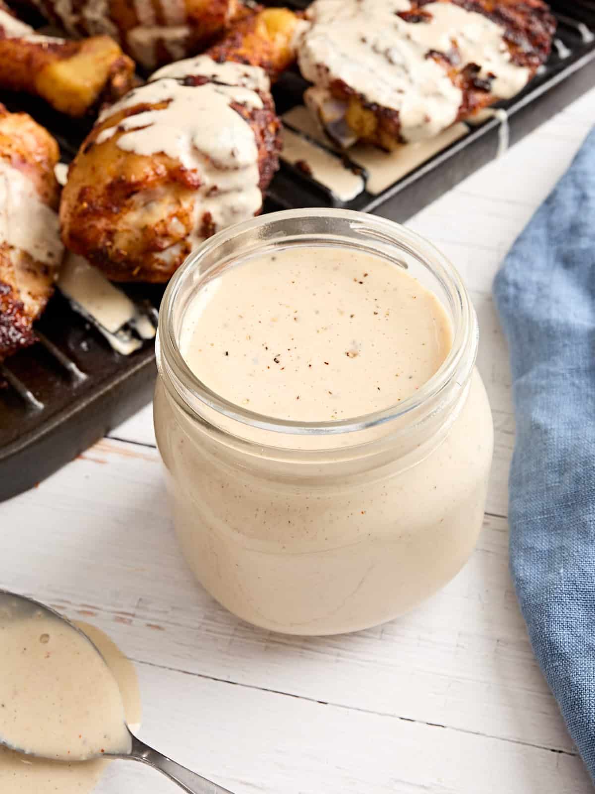 Overhead side view of a jar of alabama white sauce.