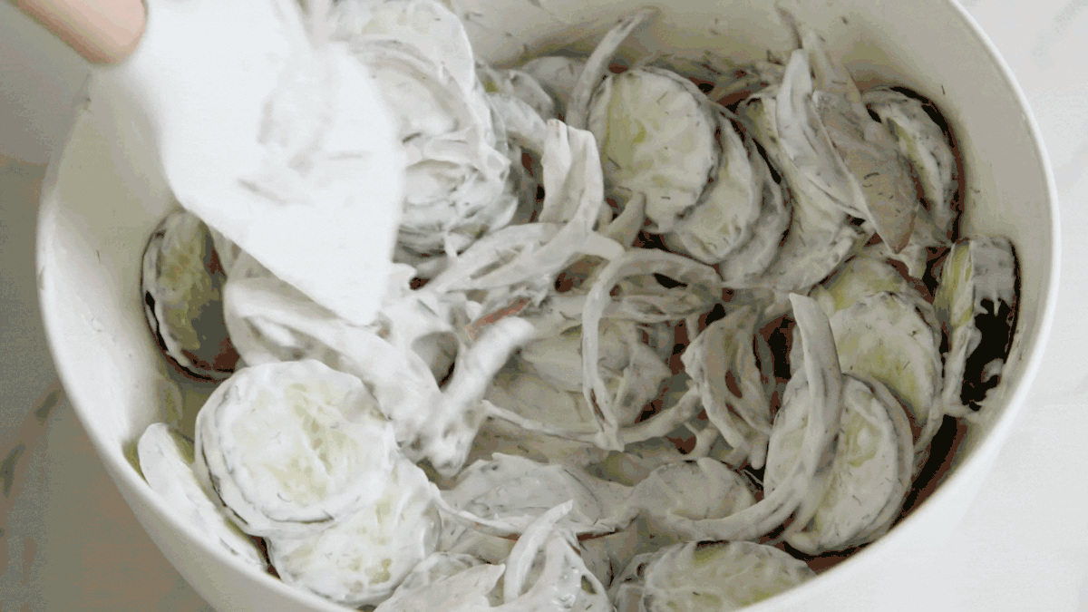 side view of a plate of creamy cucumber salad.